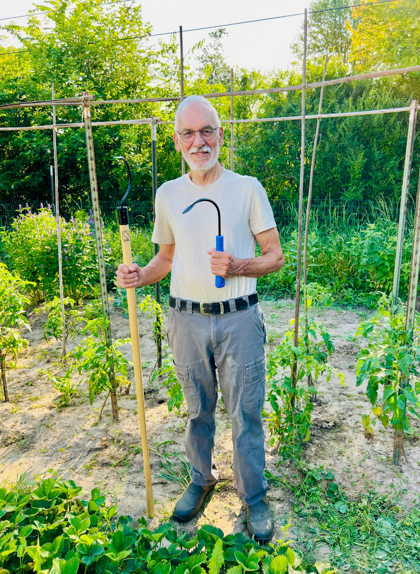noel holding the original and longhandle weeders